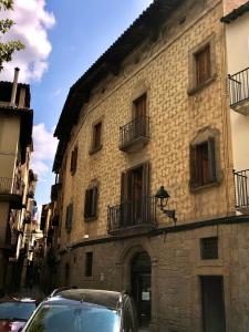 a building with a car parked in front of it at Antiga Biblioteca in Solsona