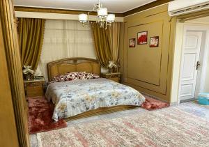 a bedroom with a bed and a chandelier at Luxury Apartment 2 Nasr City- City stars in Cairo