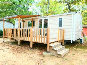 a small white house with a porch and stairs at Mobil home climatisé 6pers. 3CH camping domaine de chaussy 5* Ardèche in Lagorce