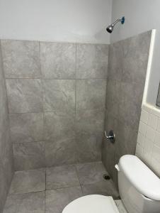 a bathroom with a shower and a toilet at Travel Inn Montgomery AL in Montgomery