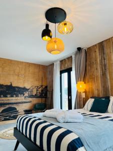a bedroom with two beds and two lights at B&B 366 in Vrboska