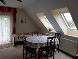 a dining room with a table and chairs and windows at Ferienwohnung für 4 PersRankwitz,Usedom in Rankwitz