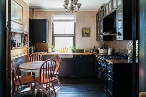 a kitchen with a table and chairs and a dining room at Cosy vintage townhouse with wood burner in Margate