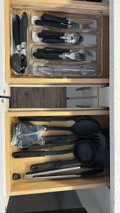 a drawer filled with lots of knives and utensils at The Refuge Retreat in Fort Worth
