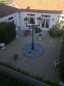 a courtyard with a street light in front of a house at Hôtel de la cloche in Vitry-le-François