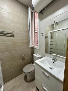 ein Badezimmer mit einem WC, einem Waschbecken und einem Spiegel in der Unterkunft Atocha Ferrocarril 5 in Madrid