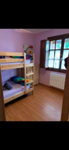 a bedroom with two bunk beds and a window at Casa Ángeles in Nueva de Llanes