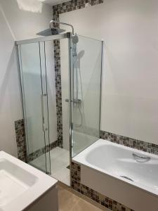 a bathroom with a glass shower and a sink at Casa Ángeles in Nueva de Llanes