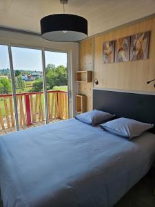 1 dormitorio con 1 cama grande y ventana grande en Chalet avec piscine, climatisation & vue de 2 à 6 personnes - Hasparren - Pays Basque - Chalet Ibaia en Hasparren