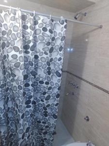 a bathroom with a shower with a shower curtain at Departamento sierras Balcarce in Balcarce