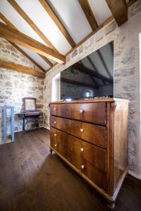 a dresser with a tv on top of it in a room at Villa Fig & Oak in Mlini