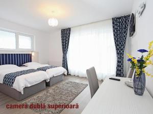 a bedroom with a bed and a table with a table sidx sidx sidx at Pension Mora in Cluj-Napoca