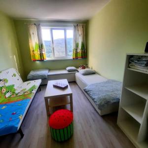 a small room with two beds and a window at "House of swallows" vacation home, close to Sofia in Makotsevo