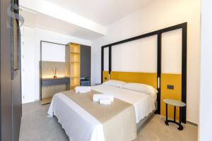 Ένα ή περισσότερα κρεβάτια σε δωμάτιο στο Sud Hotel Pulsano
