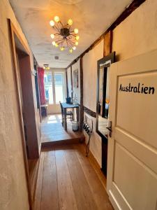 a hallway with a door and a table in a room at Hotel Pemü in Arnsberg