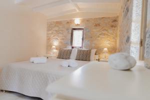 a bedroom with a large white bed with towels on it at Ampelos Tower in Kokkala