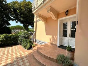 a yellow house with a white door and a patio at Villa Milada in Portorož