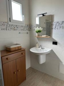 a bathroom with a sink and a mirror at LaMarticata-LikesHome Garden in Triscina
