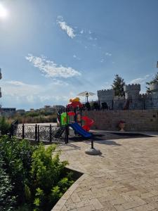 a playground with a slide and an umbrella at Premium 2 bedroom flat at Millennium 2 in Sveti Vlas