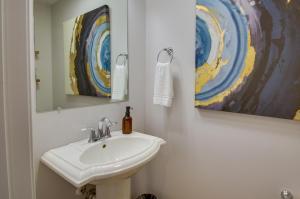 a bathroom with a sink and a mirror at Lynchburg Rental with Charcoal Grill Near Downtown! in Lynchburg