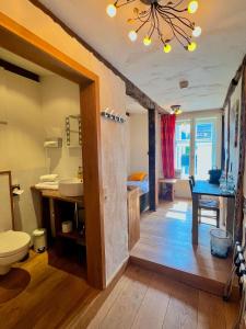 a bathroom with a sink and a toilet in a room at Hotel Pemü in Arnsberg