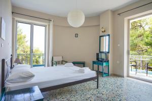 1 dormitorio grande con 1 cama y balcón en Hotel Korfos - Ξενοδοχείο Κόρφος Renovated, en Korfos