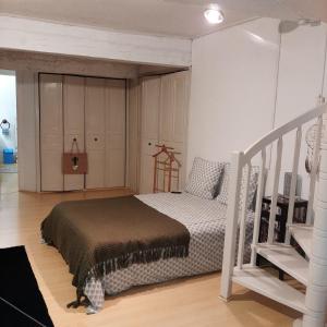 a bedroom with a bed and a staircase at Le Triplex Pézenas in Pézenas