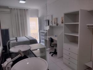 a room with a bed and a desk and a sink at Casa de Maria Suítes in Recife +84 photos