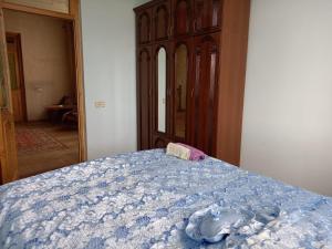 a bedroom with a bed with a blue comforter at MonaVard in Vardenis