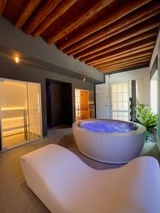 a large bath tub sitting in a room with at Villa De' Giacomi in Teolo