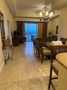 a dining room with a table and a view of the ocean at Penthouse Close to Disney area and Malls water view in Orlando