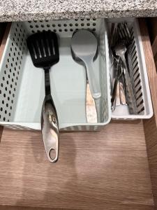 a drawer with utensils sitting on top of a counter at Arezzo Condo Staycation in Davao City