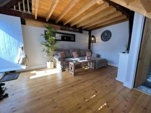 a living room with a couch and a table at The Shack - Thatched Self Contained Annex in Collingbourne Ducis