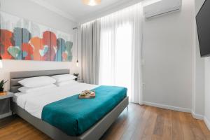 a bedroom with a large bed with a blue blanket at Harmony Sea View Apartment in Thessaloniki