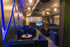 a room with blue chairs and a table and a bar at Burj Al Hayat Hotel Suites - Al Olaya in Riyadh