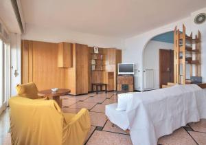 - un salon avec un lit blanc et une table dans l'établissement Dolce Acqua Flexyrent apartment Terrace & Parking - NO AC, à Rapallo