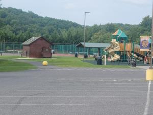 a park with a playground with a slide at Woodstone at Massanutten in Massanutten