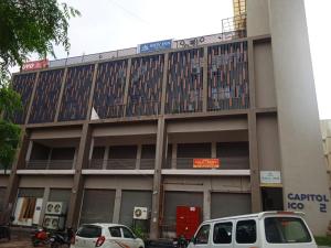 un edificio con auto parcheggiate di fronte di Hotel Shiv Inn a Gandhinagar