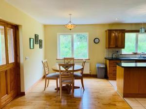 a kitchen with a table and chairs in a room at Grace's Landing in Sneem