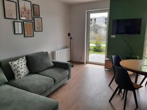 a living room with a couch and a table at Apartament na Młyńskiej in Busko-Zdrój