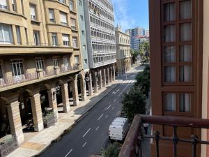 a view from a balcony of a street with buildings at El Carmen centro GIJON con GARAJE in Gijón