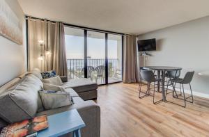 a living room with a couch and a table at 0309 The Blue Depth by Atlantic Towers in Carolina Beach +17 photos