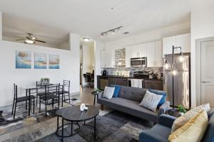 a living room and kitchen with a couch and a table at Stylish 1 Bedroom Apartment in Medical District in Dallas