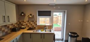 a kitchen with a sink and a window at Enchanting Escape Castle Vale in Minworth