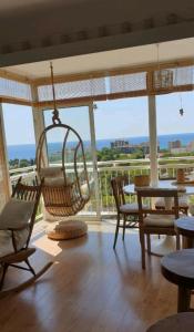 a room with a porch with chairs and a swing at PRECIOSO APARTAMENTO VISTAS AL MAR in Platja  d'Aro