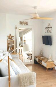 a bedroom with a bed and a living room at PRECIOSO APARTAMENTO VISTAS AL MAR in Platja  d'Aro