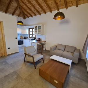 a living room with a couch and a table at JIRONI VILLA in Nikiti