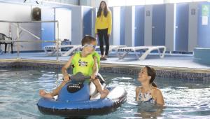 a boy and a girl in a swimming pool on an inner at Lake view in Newquay