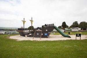 a playground with a slide in a park at Lake view in Newquay