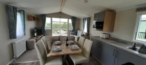 a kitchen with a table and chairs in a room at Lake view in Newquay
